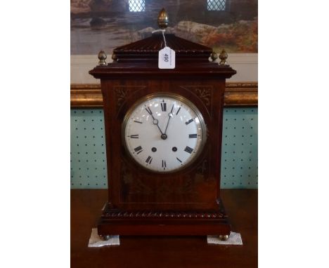 An early 20th century mahogany and brass inlaid bracket clock eight day striking movement, the enamel dial bearing Roman nume