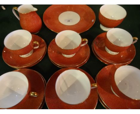 A Wedgwood part-tea service, numbered W4210, comprising: six trios, a cake plate, cream jug and sugar bowl, printed and paint