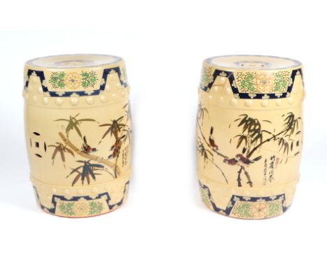 A pair of Chinese barrel form ceramic window garden seats decorated with birds amongst bamboo and calligraphy, 60cms high (on