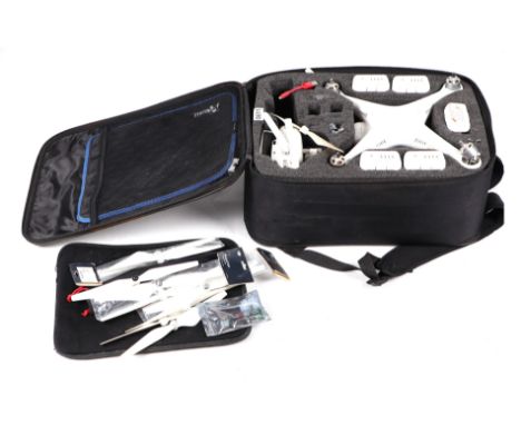 A DJI Phantom drone with spare blades and other accessories, cased.Condition ReportUnfortunately we are unsure on what model 