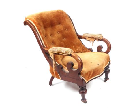 A Victorian mahogany upholstered open armchair with scroll arms, turned front legs and ceramic casters.