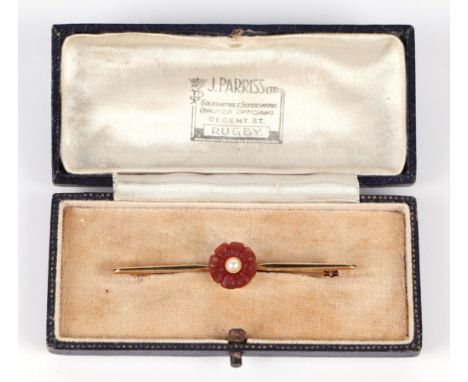 A 15ct bar brooch set with a central flower, pearl and possibly carnelian, 3.6g (boxed).