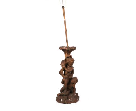 A plaster figural standard lamp depicting two putti, overall 145cms high.