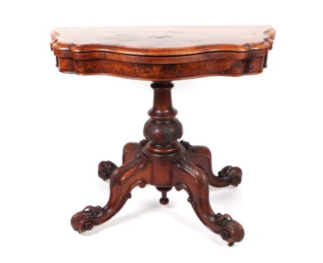 A Victorian burr walnut card table on turned and carved column and quatrefoil base, 90cms wide.