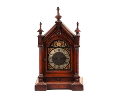 An Edwardian walnut architectural mantle clock, the brass dial with silvered chapter ring and Roman numerals, fitted with an 