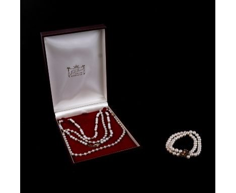 Two pearl necklaces with 14ct gold clasps and yellow metal spacers; together with a double strand pearl bracelet with silver 