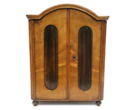 A French vintage miniature walnut and rosewood doll's armoire with interior shelves and clothes rail, 51cms high.