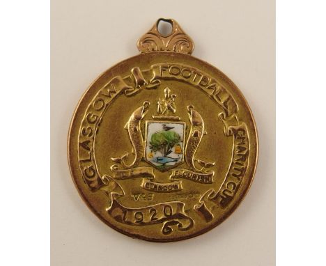 A 9ct Glasgow Football Medal for the charity cup. Presented to the winning players in 1920, Celtic FC, with the Glasgow Coat 