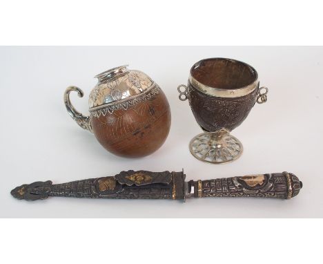 A 19th Century white metal mounted gourd wine cup the gourd engraved with geometric designs, the white metal mount embossed w