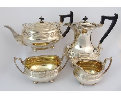 A four piece silver tea service by James Dixon & Sons, Sheffield 1919, of rounded rectangular form with gadrooned rim and a r