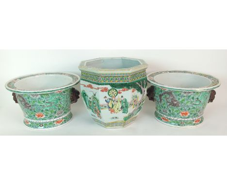 A pair of Chinese famille verte jardinieres painted with dragons on a seed and scroll pattern ground, mask handle, (damages t