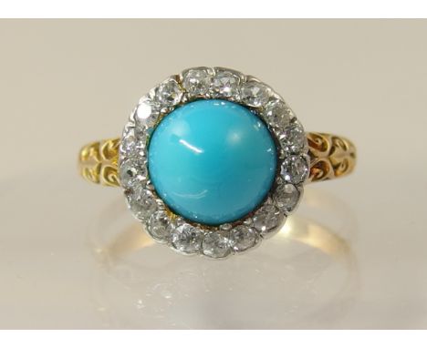 An 18ct turquoise and diamond ring the high turquoise cabouchon is set within a circlet of old cut diamonds, with a galleried