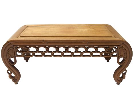A Chinese hardwood low rectangular table with pierced interlaced frieze on scroll shaped legs, 100cm wide