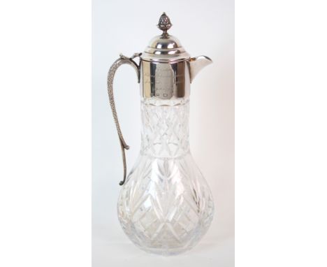 A silver topped cut glass claret jug by P H Vogel & Co., Birmingham 1989, the body pear shaped, the silver mount with hinged 