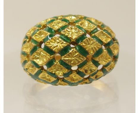 An 18ct yellow gold lattice enamel ring the centres in a floral boss pattern surrounded with a delicate row of green enamel p