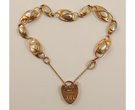 A 9ct Art Nouveau bracelet the rose gold units are of whip lash design are each set with blister pearls Hallmarked BHJ 9ct, l