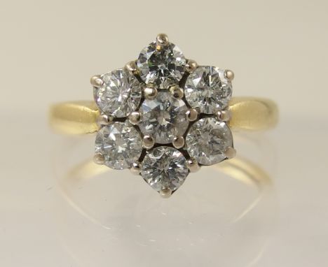 An 18ct diamond daisy cluster ring with an approximate diamond total of 0.80cts, finger size M.