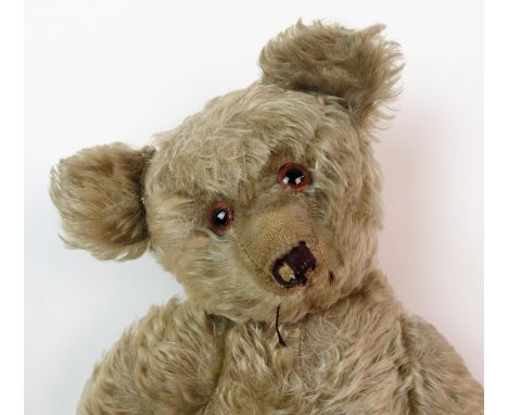 A 1940's Steiff plush mohair teddy bear with glass eyes and red pads, 63cm high (missing ear button) - Please note, photograp