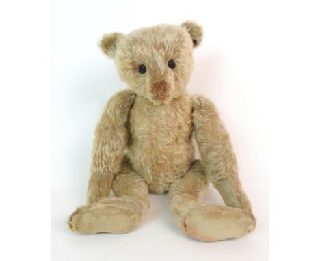 An early Steiff teddy bear circa 1906 button in ear, slightly corroded, white with red stitched nose, shoe-button eyes and hu