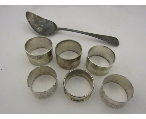 A Georgian silver spoon a/f, four silver napkin rings and a pair of plated examples 