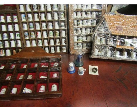 A cased collection of mainly ceramic thimbles