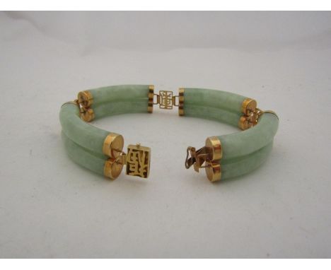 A jade link bracelet with yellow metal links stamped 585, 19cm long