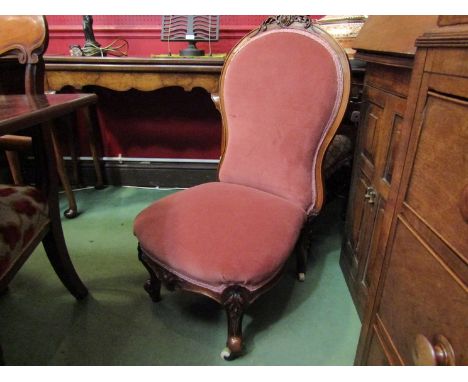 An early Victorian walnut bedroom chair the spoon backrest with carved crest over scroll front carved legs on white ceramic c