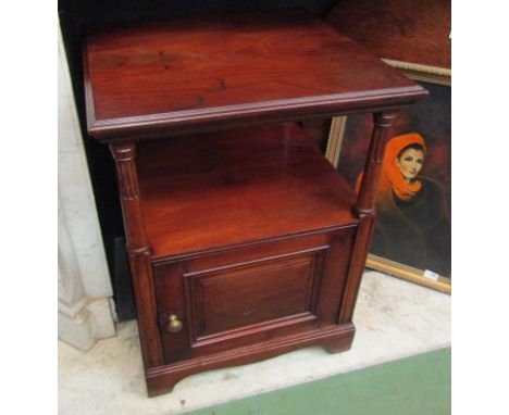 A Victorian walnut two tier night stand on turned and reeded supports the single door cupboard and panelled sides over cerami