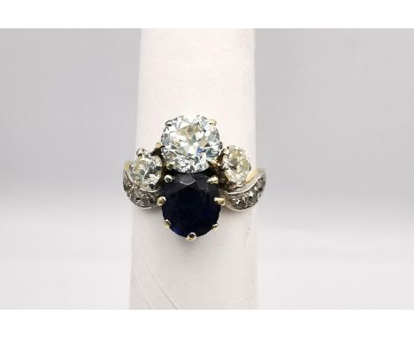 An Art Nouveau old mine diamond and sapphire two stone yellow (18ct gold) and white metal (platinum) dress ring. Set with a c