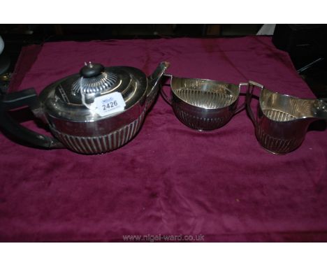 A Silver Teapot and matching sugar basin and cream jug by W. Hutton &amp; Sons, London 1897, 921 gms.