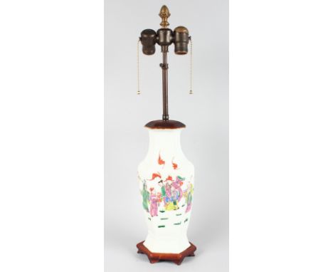 A 19TH CENTURY CHINESE PORCELAIN HEXAGONAL VASE painted with figures, 12ins high, on a wooden base converted to a lamp.