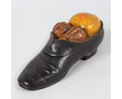 A GOOD 19th CENTURY TREEN "SHOE" INKWELL, the top carved with an apple and a pair of walnuts opening to reveal an inkwell. 7i