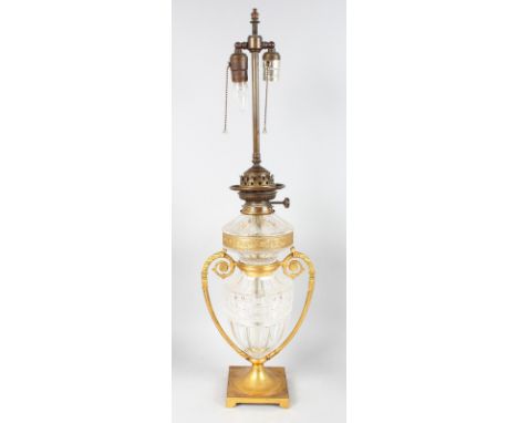 A GOOD ORMOLU AND CRYSTAL TWO HANDLED URN converted to a lamp, on a square base with bracket feet. 28ins high.