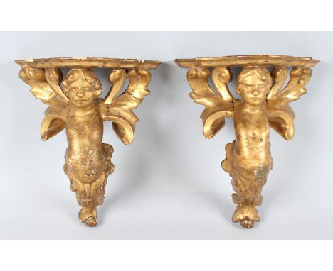 A SMALL PAIR OF CARVED AND GILDED WALL BRACKET. 11ins long.