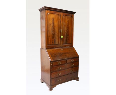 A LARGE GEORGE III MAHOGANY BUREAU BOOKCASE, the top with plain double panel doors enclosing a single shelf, candle slides be
