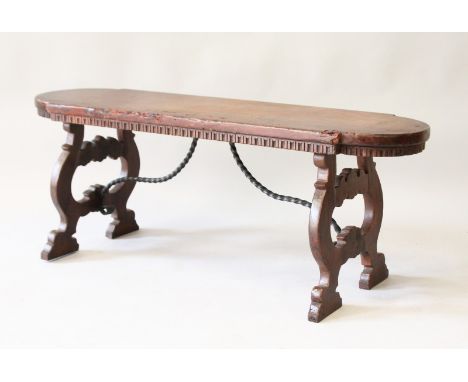 AN 18th - 19th CENTURY ITALIAN WALNUT SHAPED BENCH with shaped end supports and wrought iron. 3ft 9ins long.