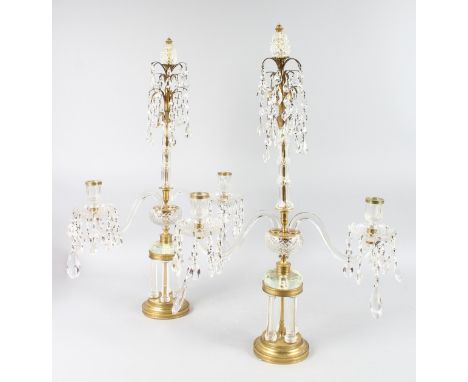 A SUPERB PAIR OF REGENT CRYSTAL AND ORMOLU TWO LIGHT CANDELABRA with two curving arms, prism drops on four  column circular b