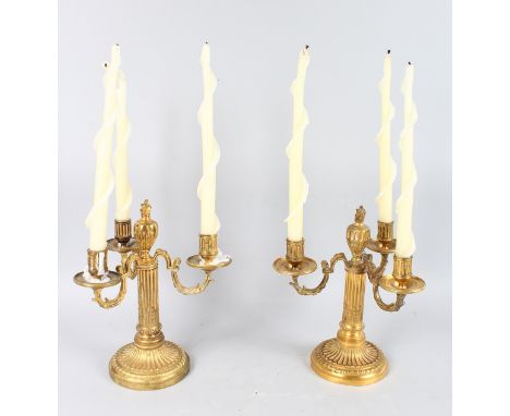 A GOOD PAIR OF 19th CENTURY ORMOLU THREE LIGHT CANDELABRA with fluted columns on circular bases. 11.5ins high.