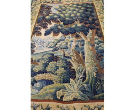 A GOOD LARGE FLEMISH TAPESTRY PICTURE, woodland scene with a bird on a branch In a floral garden. 10ft 6ins x 6ft 0ins.