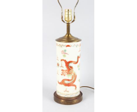 AN 18TH CENTURY CHINESE PORCELAIN VASE painted with dragons, 11ins high, on a gilt base and converted to a lamp.