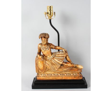 AN 18th CENTURY CARVED AND GILDED ITALIAN FIGURE, 11ins high on a wooden base, converted to a lamp.
