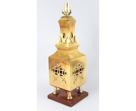 A LARGE ORIENTAL BRASS LAMP with pierced decoration, on a square base. 22ins high.