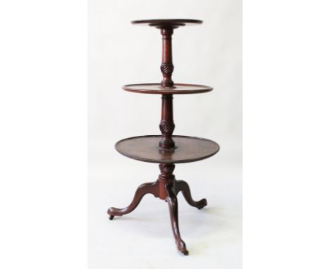 A GEORGIAN MAHOGANY THREE TIER CIRCULAR DUMB WAITER with central turned column ending in a tripod base. 3ft 11ins high.