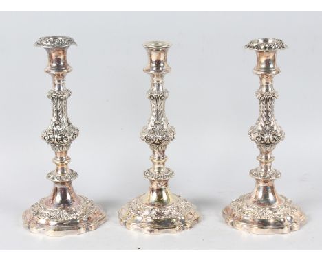 A PAIR OF VICTORIAN PLATED CANDLESTICKS and another similar stick. All 10.5ins high.