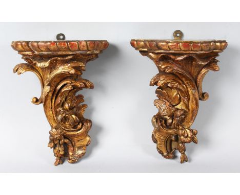 A SMALL PAIR OF 18th CENTURY CARVED WOOD AND GILDED WALL BRACKET scrolls and flowers. 9ins long.