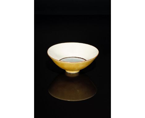 ‡ Dame Lucie Rie D.B.E (1902-1995) an early porcelain footed bowl, the flaring conical bowl glazed yellow to the exterior, th