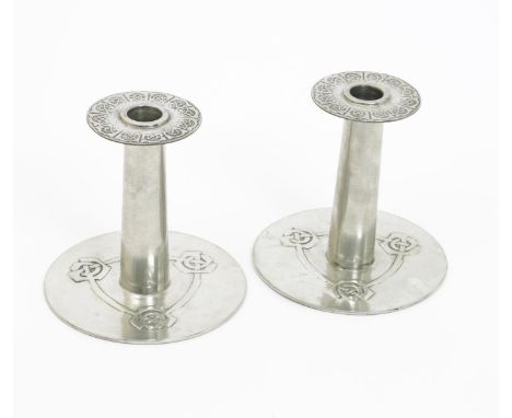 A pair of Liberty & Co English Pewter Thousla candlesticks designed by Archibald Knox, model no.08, flat, circular base suppo