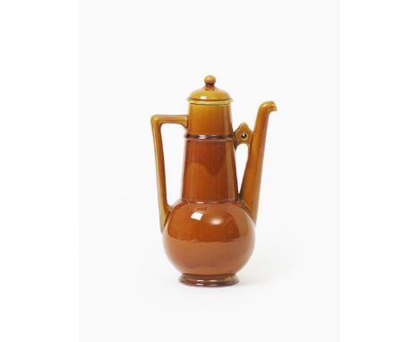 A Linthorpe Pottery coffee pot and cover designed by Dr Christopher Dresser, model no.647, covered in a crackled amber glaze,