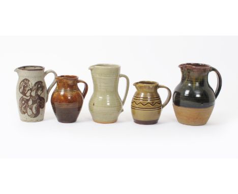Leach Pottery a stoneware jug, ovoid with cylindrical neck and strap handle, covered to the foot with a celadon glaze with ru
