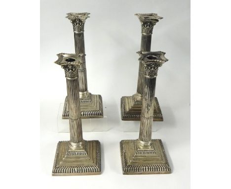 A set of four Mappin and Webb silver candlesticks, modelled as Corinthian columns, raised on stepped bases, Sheffield 1896, h